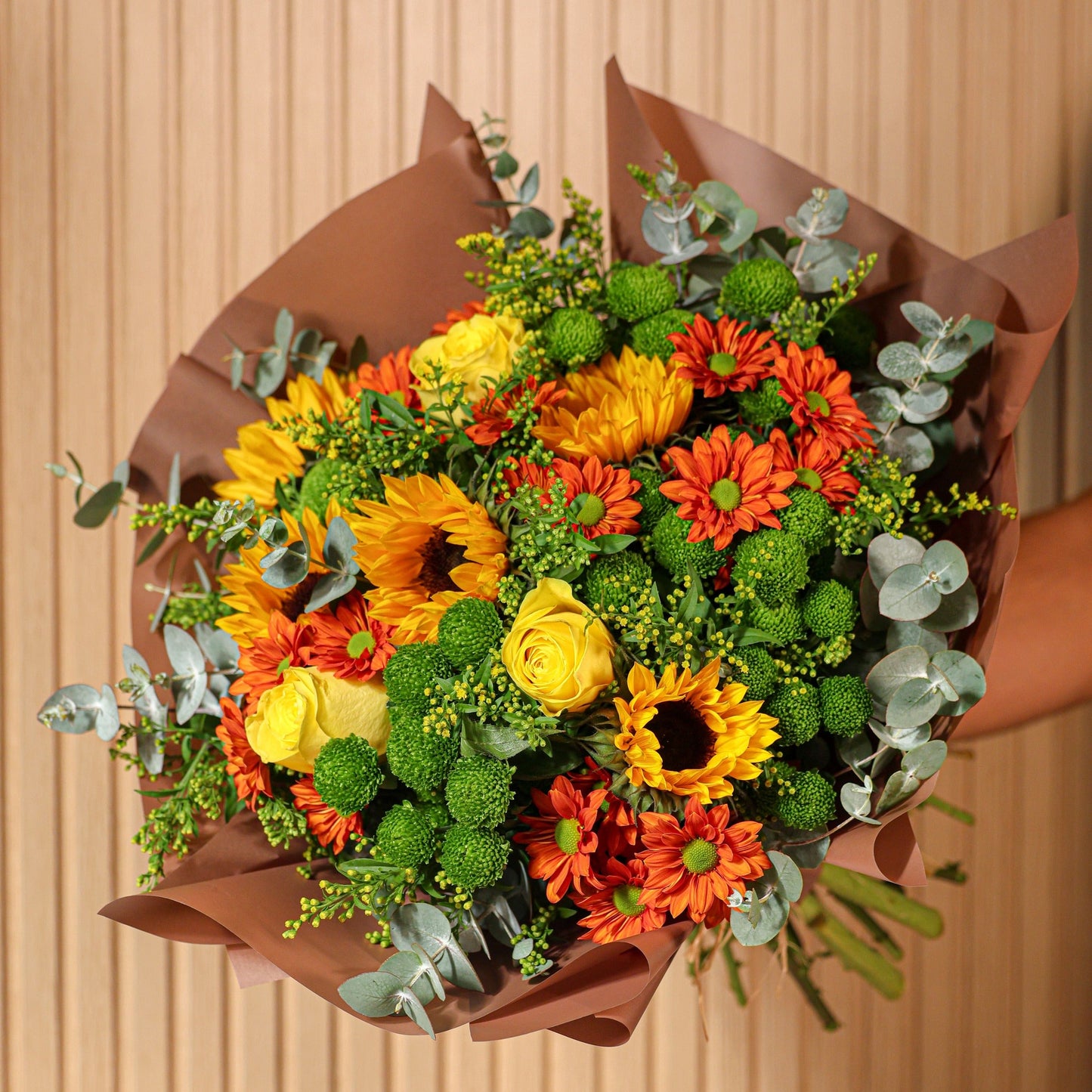 Detalle de girasoles y crisantemos naranjas del ramo Alma de Sol estilo otoñal