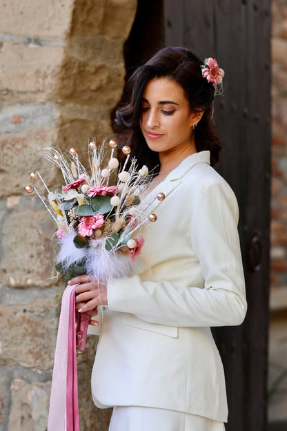 Novia moderna sosteniendo ramo de flores preservadas con estructura abanico, tonos rosados y beige